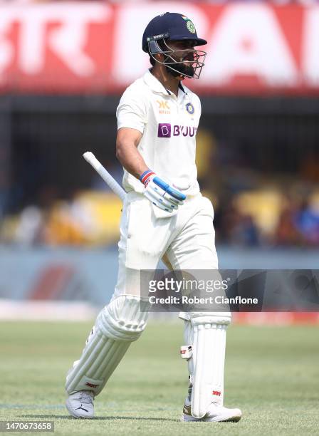 Virat Kohli of India walks off after he was dismissed by Matthew Kuhnemann of Australia during day two of the Third Test match in the series between...