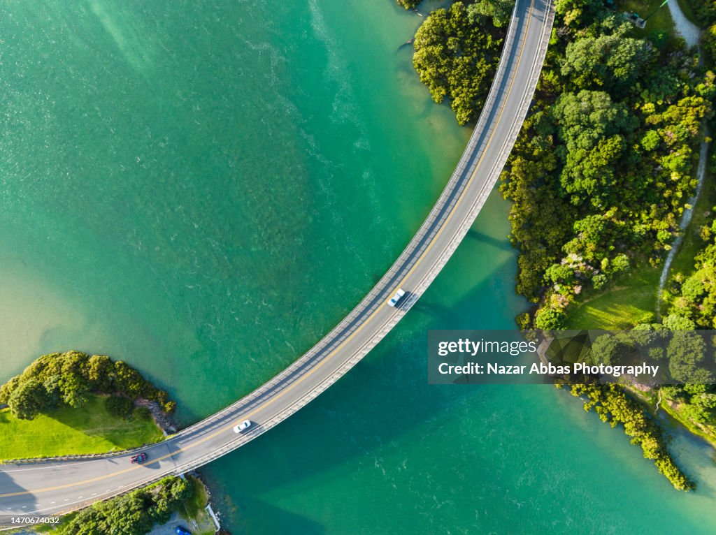 Cars passing through bridge that connecting two sides.