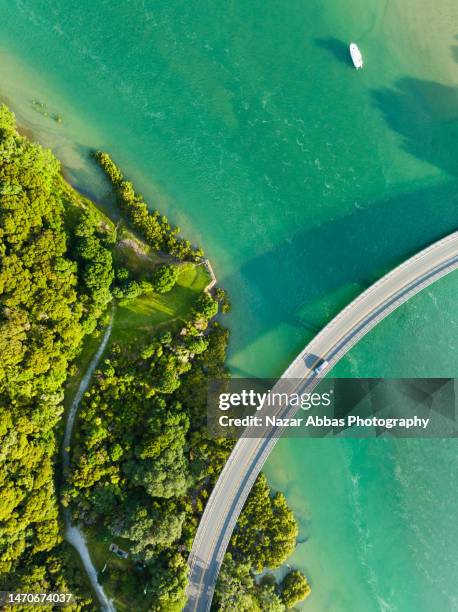 top aerial view of a river and a bridge. - nazar abbas photography stock pictures, royalty-free photos & images