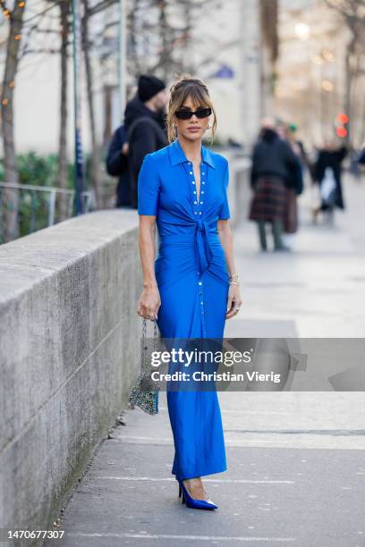 Camila Coelho wears blue dress, silver bag outside Paco Rabanne during Paris Fashion Week - Womenswear Fall Winter 2023 2024 : Day Three on March 01,...