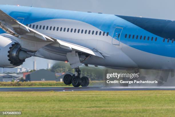 close up photo of passenger aircraft landing gear during take off - landing gear stock-fotos und bilder