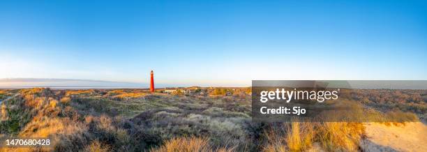 schiermonnikoog panoramic view in the dunes with the lighthouse during sunset - wattenmeer national park stock pictures, royalty-free photos & images