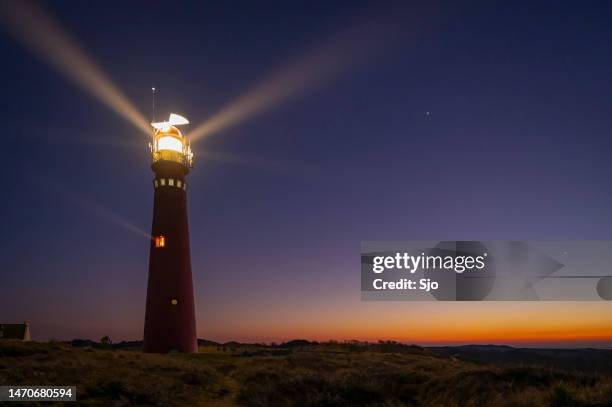 lighthouse at schiermonnikoog island in the dunes during sunset - schiermonnikoog stock pictures, royalty-free photos & images