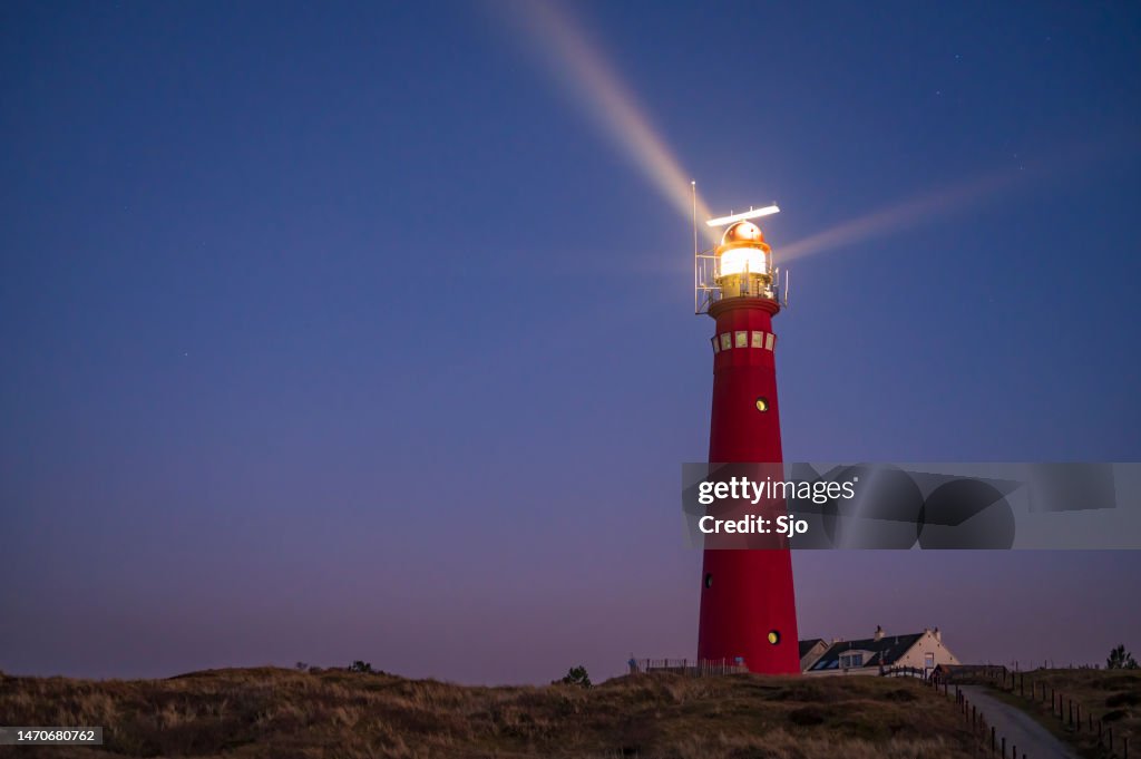 Lighthouse at Schiermonnikoog island in the dunes during sunset