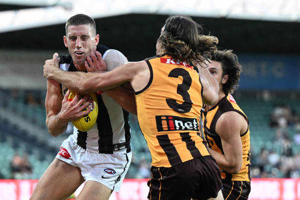 Darcy Cameron of the Magpies is tackled by Jai Newcombe of the Hawks during the AFL practice match between the Hawthorn Hawks and the Collingwood...