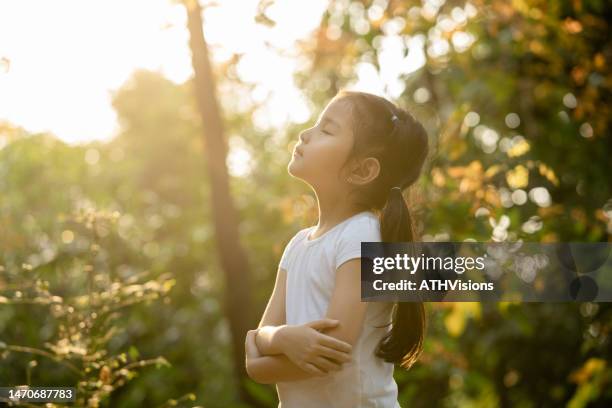 toddler girl relax and breathing fresh air at park in the weekend - mindfulness stock pictures, royalty-free photos & images