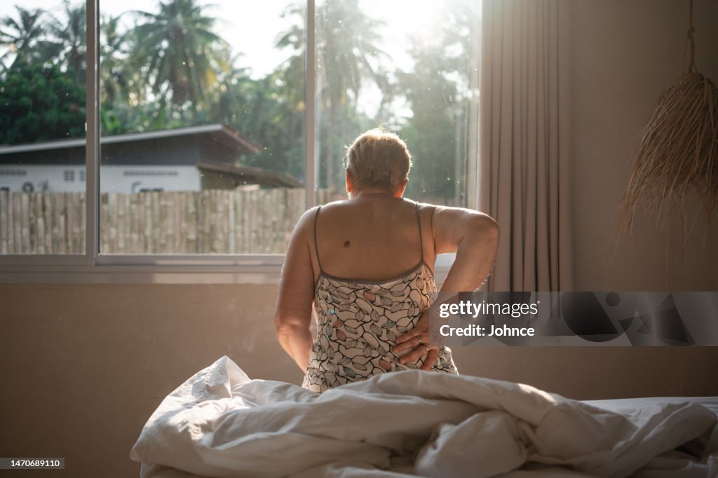 Senior woman struggles with backache