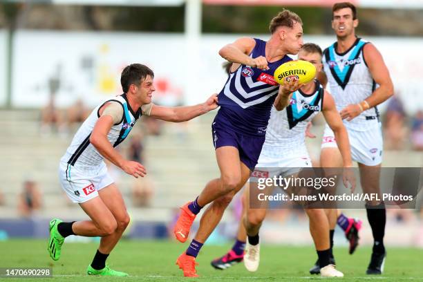 Will Brodie of the Dockers handballs the ball away to get the clearance during the AFL Practice Match between the Fremantle Dockers and the Port...