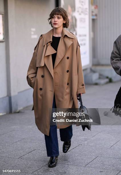 Guest is seen wearing a tan trench coat and Dior bag outside the Dries Van Noten show during Paris Fashion Week F/W 2023 on March 01, 2023 in Paris,...