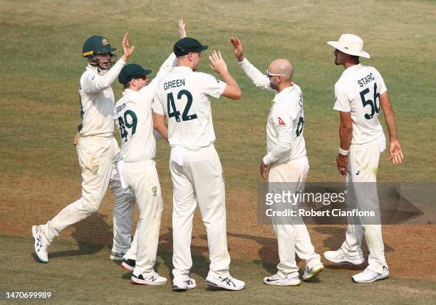 Nathan Lyon of Australia celebrates taking the wicket of KS Bharat of India during day two of the Third Test match in the series between India and...