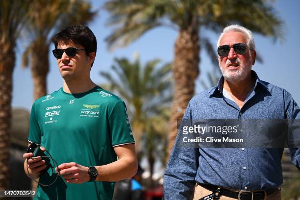 Lance Stroll of Canada and Aston Martin F1 Team and Owner of Aston Martin F1 Team Lawrence Stroll talk in the Paddock during previews ahead of the F1...