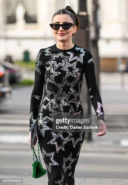 Guest is seen wearing a black and silver star Paco Rabanne dress and green bag outside the Paco Rabanne show during Paris Fashion Week F/W 2023 on...