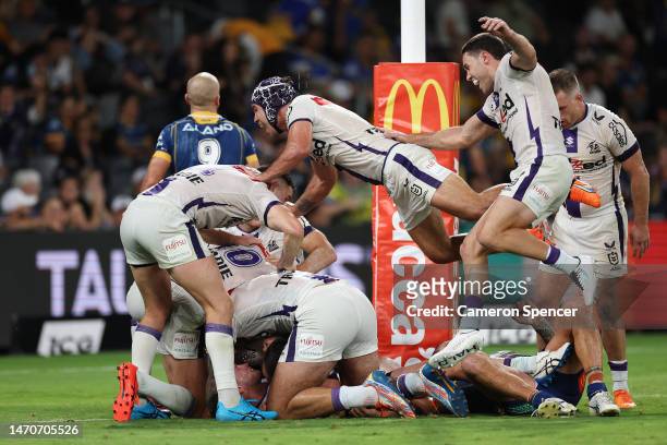 Harry Grant of the Storm celebrates scoring a match winning try with team mates in golden point extra time during the round one NRL match between the...