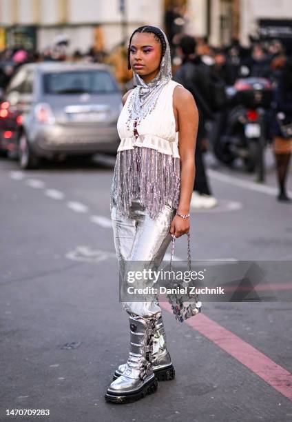 Paola Locatelli is seen wearing a silver Paco Rabanne fringe top, silver pants, Paco Rabanne boots, bag and headpiece outside the Paco Rabanne show...
