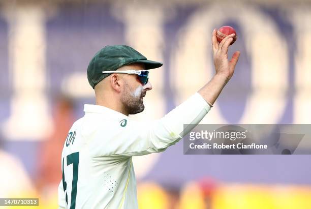 Nathan Lyon of Australia holds up the ball after he took eight wickets in the second innings during day two of the Third Test match in the series...