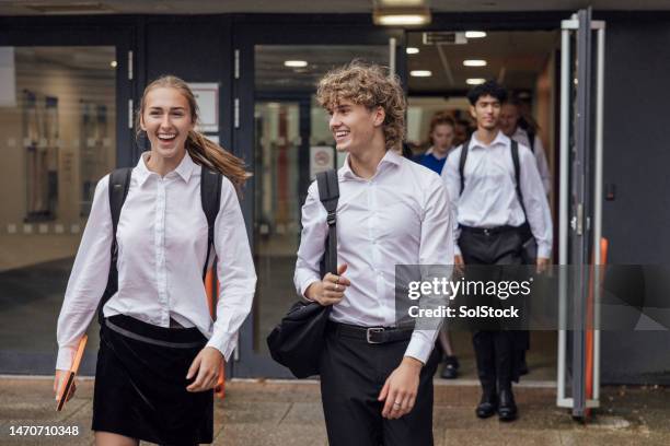 taking a break from class - schooluniform stockfoto's en -beelden