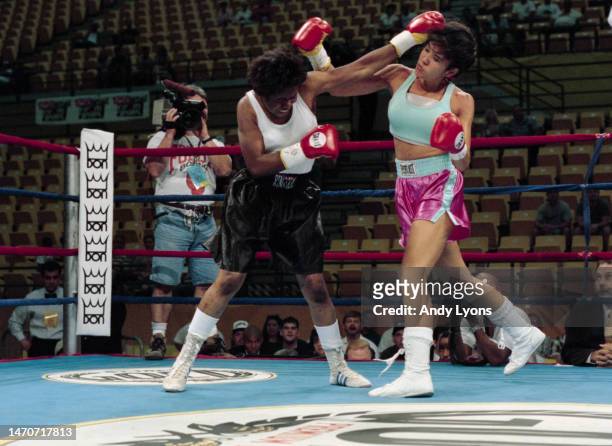 Boxer Mia Rosales St John from the United States trades punches with Contina Frederick during their Featherweight fight on 21st June 1997 at the Sun...