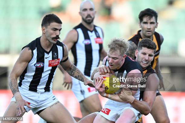 John Noble of the Magpies is tackled by Luke Breust of the Hawks during the AFL practice match between the Hawthorn Hawks and the Collingwood Magpies...