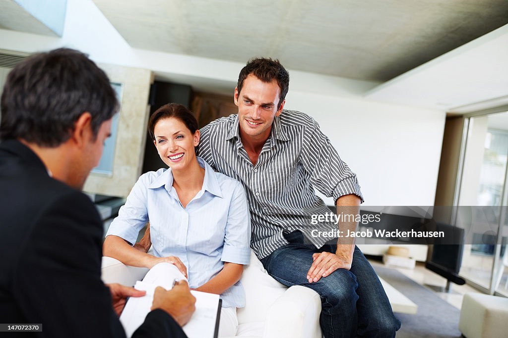 Consultant advising a young couple at home