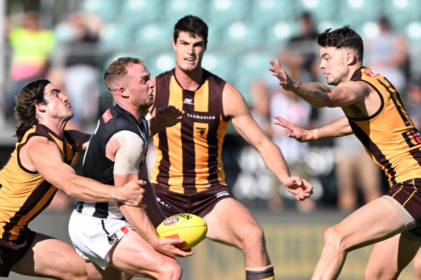 Tom Mitchell of the Magpies is tackled by Jai Newcombe of the Hawks during the AFL practice match between the Hawthorn Hawks and the Collingwood...