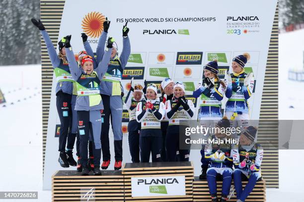 Silver medalists Team Germany celebrate as gold medalists Team Norway and bronze medalists Team Sweden look on during the victory ceremony for the...