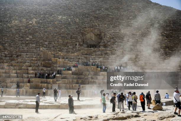 Tourists visit the Great Pyramid of Khufu Cheops at the Giza Pyramids necropolis on the southwestern outskirts on March 2, 2023 in Giza, Egypt. The...