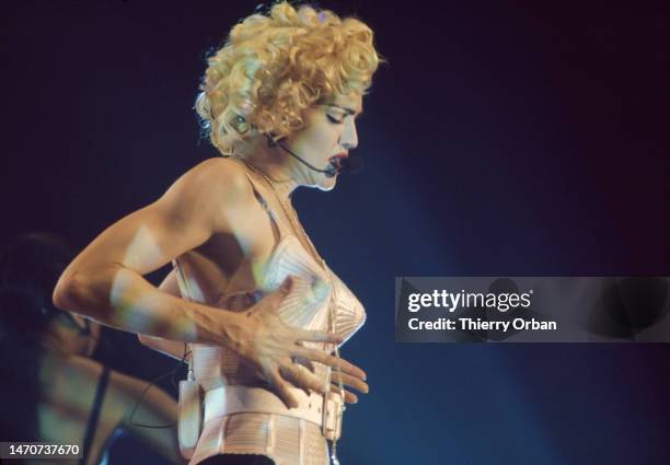 Madonna performs on stage at Paris Bercy, France on the Blond Ambition World Tour. She wears the famous outfit designed by Jean-Paul Gaultier.