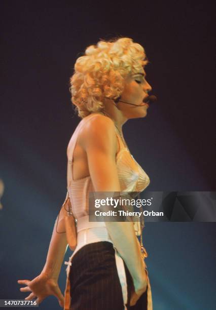 Madonna performs on stage at Paris Bercy, France on the Blond Ambition World Tour. She wears the famous outfit designed by Jean-Paul Gaultier.