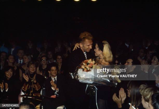 French fashion designer Jean-Paul Gaultier offering a bouquet of flowers to Madonna during 1991 Spring-Summer fashion show.