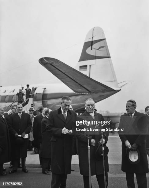 German politician Konrad Adenauer, Chancellor of West Germany, wit men after his arrival at Gatwick Airport near Crawley, West Sussex, England, 14th...