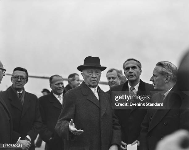 German politician Konrad Adenauer, Chancellor of West Germany, wit men after his arrival at Gatwick Airport near Crawley, West Sussex, England, 14th...