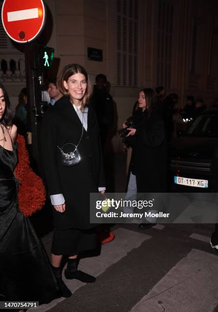 Veronika Heilbrunner seen wearing Acne Studios light blue / white striped button shirt, pearl earrings, Self Portrait shiny leather glitter bow...