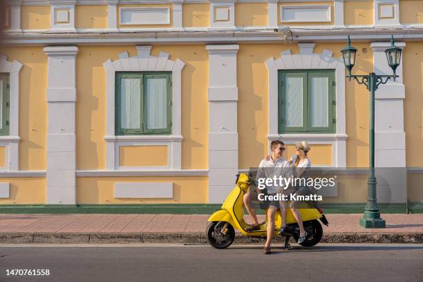 young couple with retro motorcycle in oldtown streets of bangkok thailand. - summer romance stock pictures, royalty-free photos & images