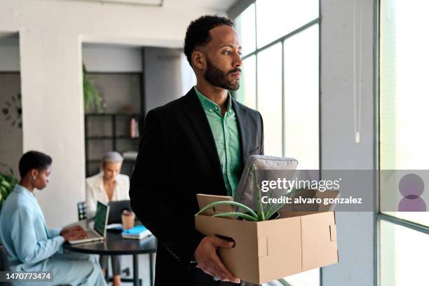 african businessman being fired from office - layoffs and unemployment concept - being fired stock pictures, royalty-free photos & images