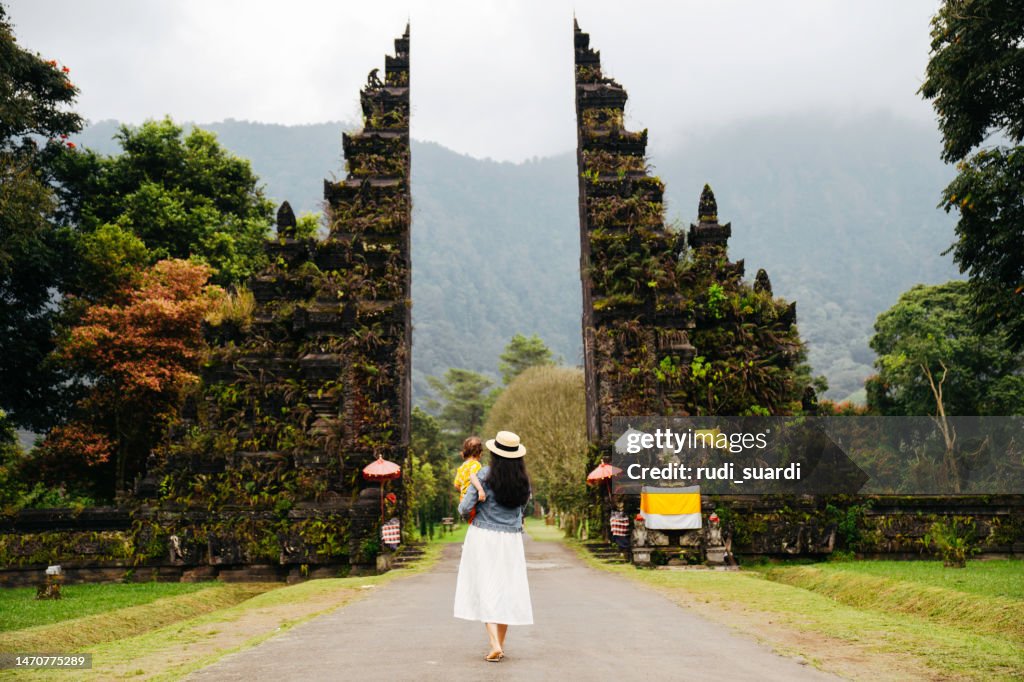 Young woman with her baby in Bali Handara Gate