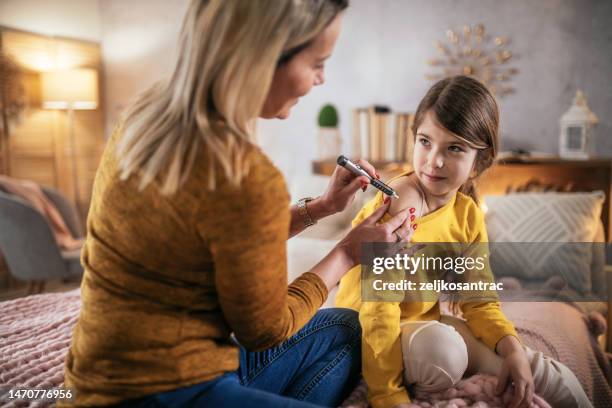 diabetic girl taking an insulin in hers arm - injection pen stock pictures, royalty-free photos & images