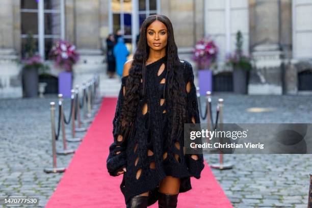 Ciara wears black cut out dress, black varnished boots Roger Vivier at Maison de l’Amérique latine on March 02, 2023 in Paris, France.