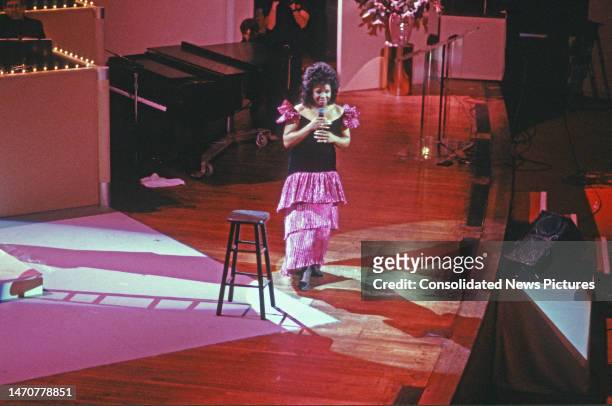 Elevated view of American signer Gladys Knight as she performs onstage during 'AIDS Concert '88' at the John F Kennedy Center for the Performing...