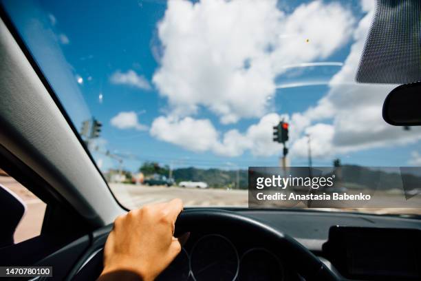 driver in a car waiting at red traffic light - car traffic light stock pictures, royalty-free photos & images
