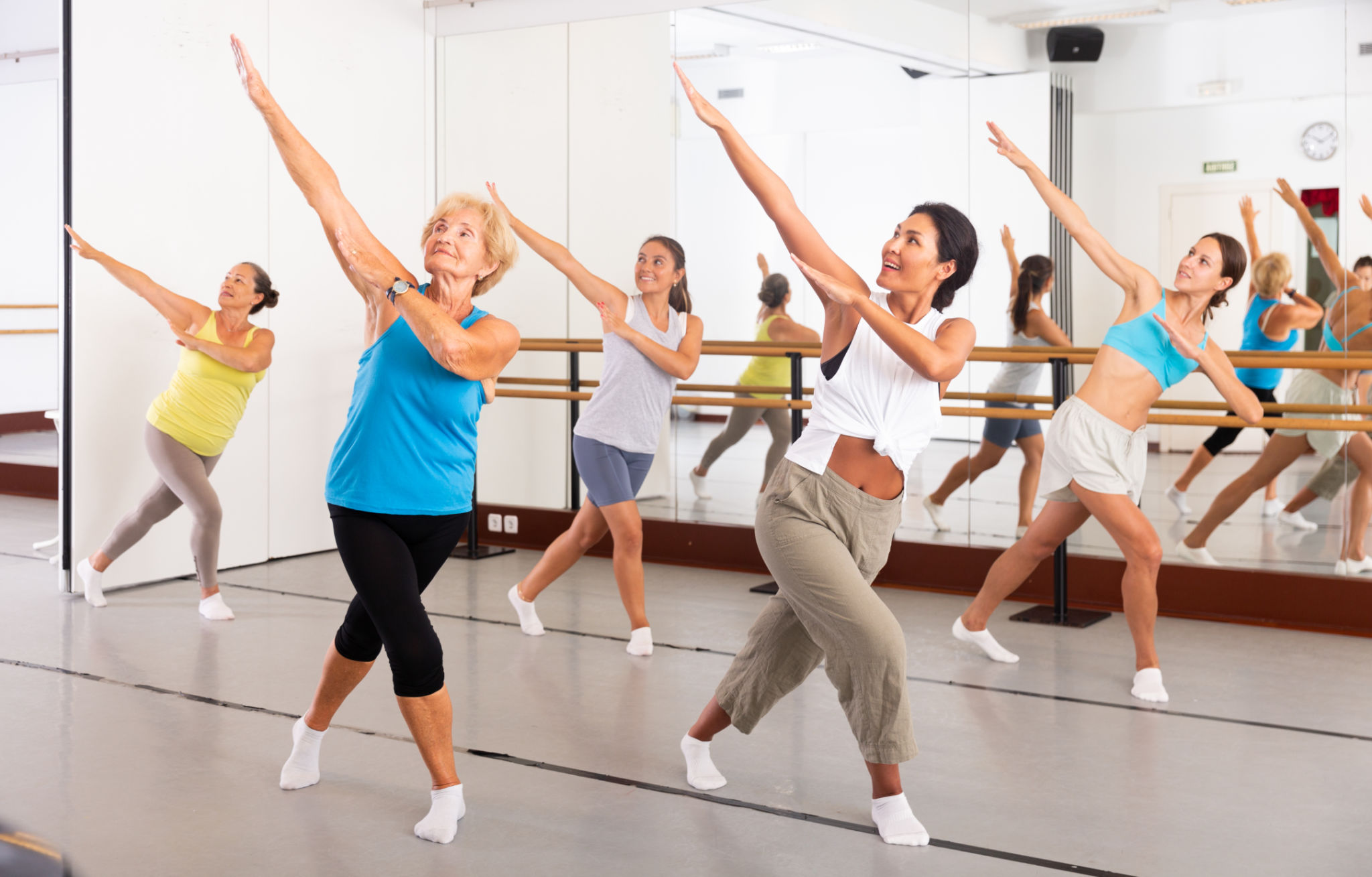 Dance class for adult people, positive young and mature women training in studio Dance class for adult people, positive young and mature women training in studio