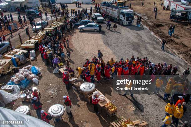 earthquake survivors and volunteers during the meal - international red cross and red crescent movement stock pictures, royalty-free photos & images