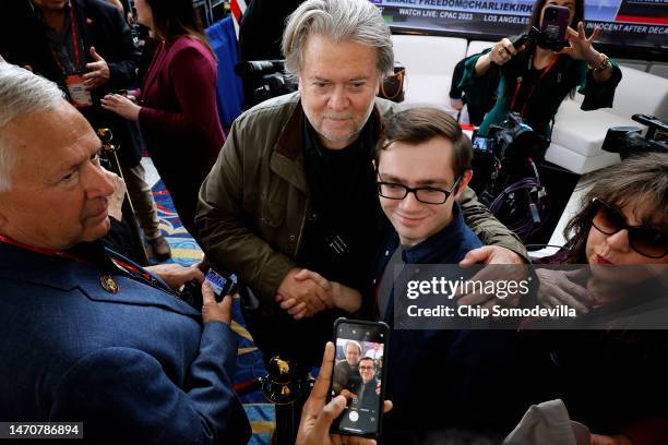 Steve Bannon, former advisor to former President Donald Trump and right-wing media executive, poses for selfies with supporters during the...