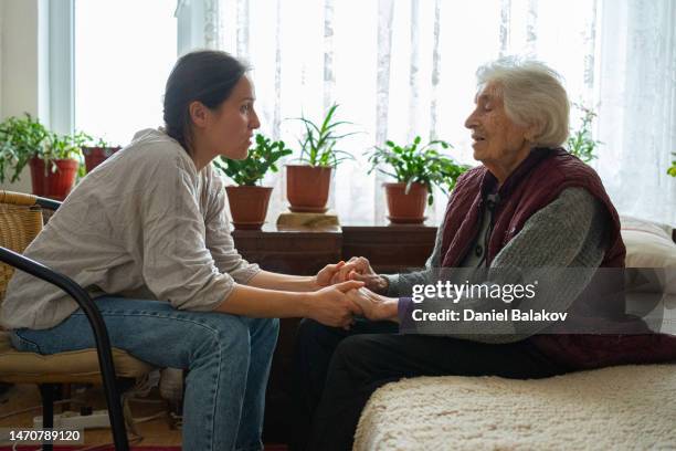 a helping hand. volunteering and senior care. - cuidar se imagens e fotografias de stock