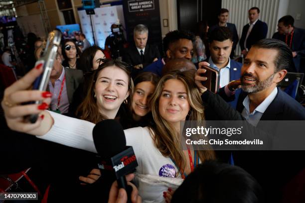 Donald Trump Jr. Poses for a selfie with supporters during the Conservative Political Action Conference at Gaylord National Resort Hotel And...