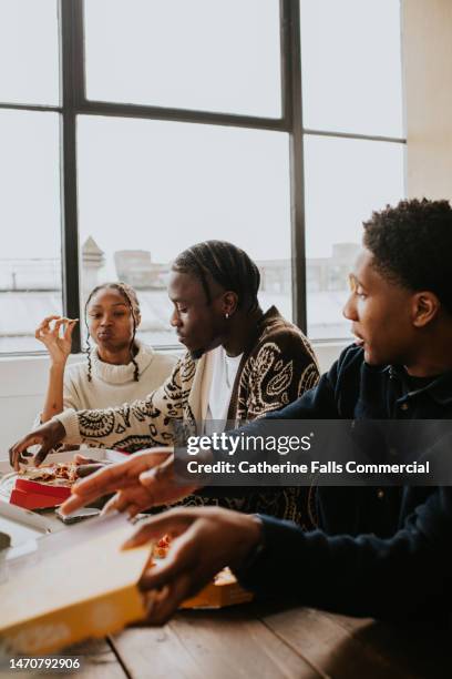 young people share takeaway pizzas - black knob stock pictures, royalty-free photos & images