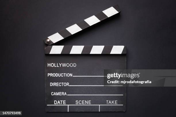 movie clapper board on a black background - clap de cinéma photos et images de collection