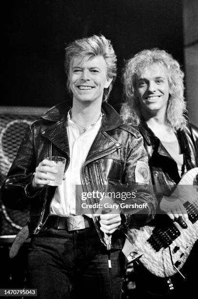 British musicians David Bowie and Peter Frampton, the latter on guitar, perform onstage during a press conference at the Cat Club, New York, New...