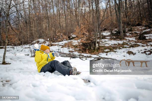 mother and son having fun on snow - melting snowball stock pictures, royalty-free photos & images