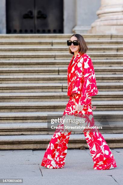 Influencer and style icon Annette Weber, wearing a red-white patterned suit by Dawid Tomaszewski, shoes by Valentino, a beige cashmere pullover by...