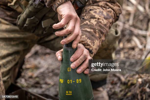 Members of Ukraine's 10th Mountain Brigade arm artillery shells before firing on Russian positions on March 02, 2023 in the Donetsk Region of eastern...